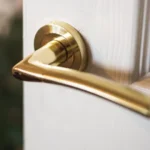 Golden door handle on a withe door