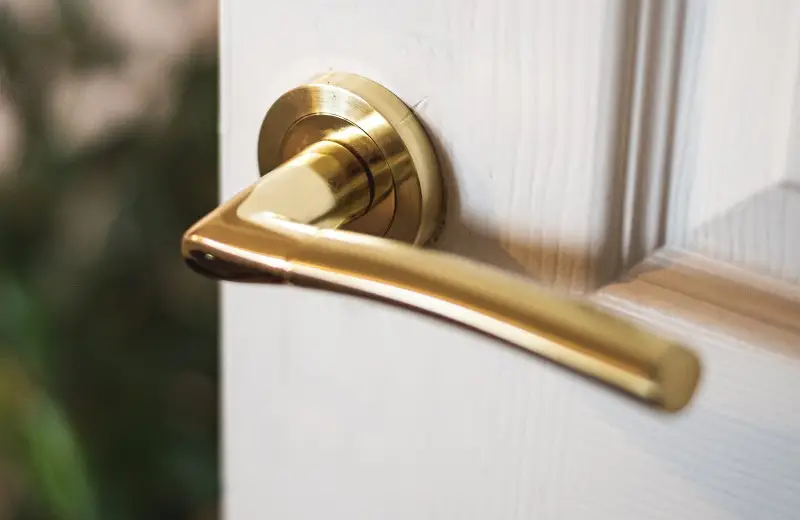 Golden-door-handle-on-a-withe-door